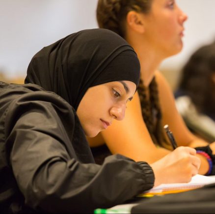 Student taking notes in class