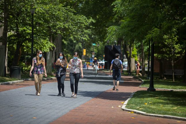 Students masked walking on campus