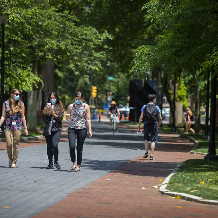 Students masked walking on campus